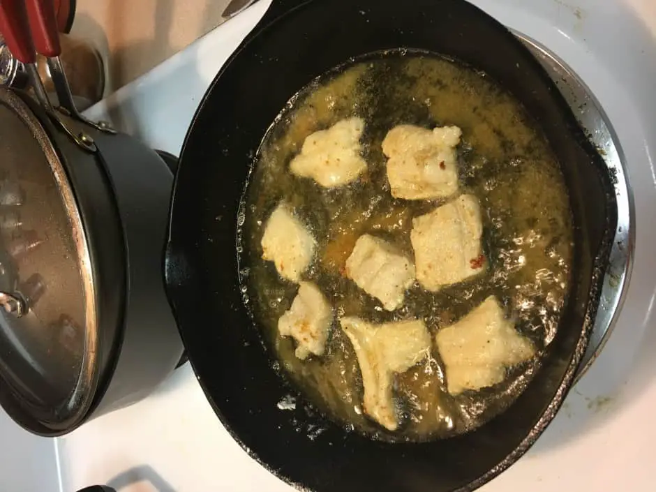 fish frying in pan