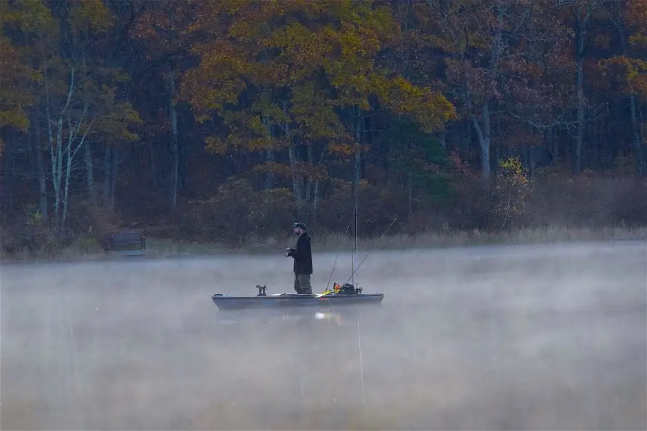 dawn boat fishing in the morning mist